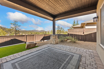 Fototapeta premium Invite Relaxation In Warm Outdoor Setting With Textured Ceiling And Scenic Mountain Backdrop