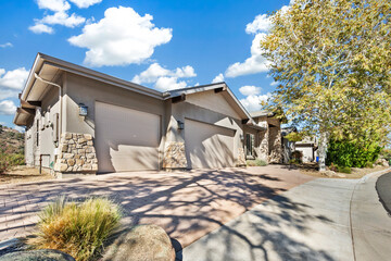 Bright Home Exterior Displaying Stone Accents And Desert Landscaping Perfect For Marketing © Allison