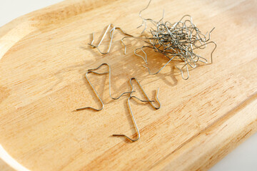 christmas ornament hooks on wooden tray for hanging holiday decorations