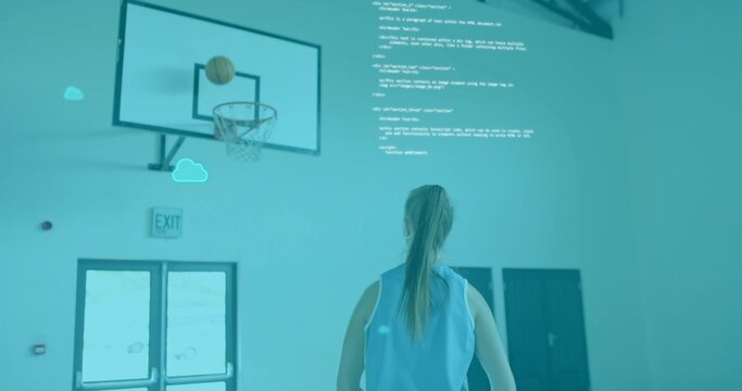 Standing woman wearing light-blue jersey watching basketball over hoop in gym, digital overlay - Powered by Adobe