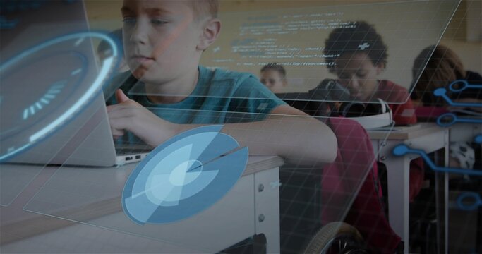 Typing boy in teal shirt working on laptop at school desk, showing AR overlays and wheelchair