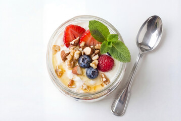 Greek yogurt with nuts, strawberries, raspberries and mint