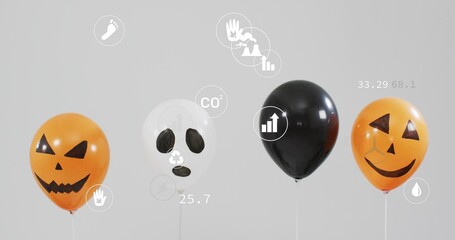 Fototapeta premium Displaying 4 balloons: 2 jack-o'-lanterns, 1 skull, 1 black on white sticks in studio, infographics