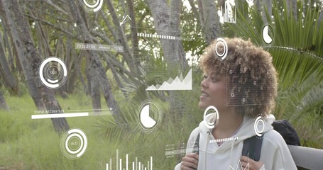 Standing woman right wearing light hoodie with dark backpack, viewing AR overlays, copy space