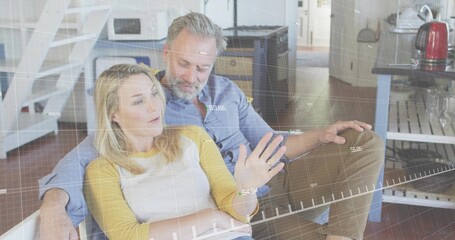 Talking couple leaning on couch in living area, woman in white top yellow sleeves, digital grid