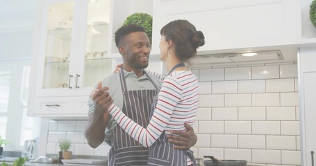 Cooking couple wearing striped aprons making dinner in home kitchen, frying pan on stove © vectorfusionart