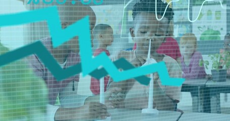 Studying boy in light shirt holding wind turbine model at face in class, turquoise graph overlay