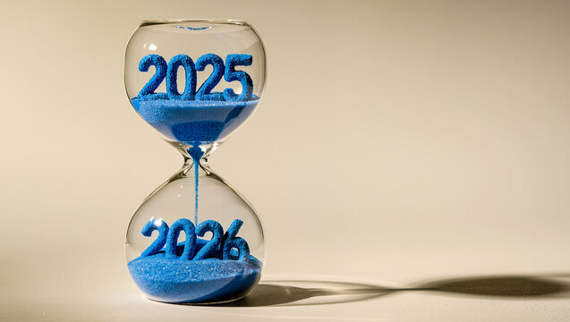 Hourglass with blue sand forming 2025 and 2026 as time flows between years symbolizing transition, countdown and new year change concept