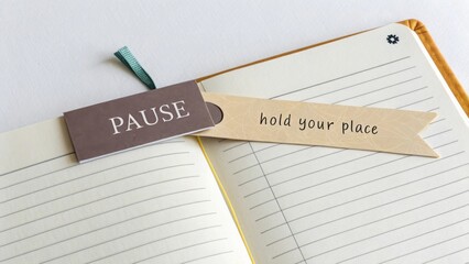 Book with bookmarks labeled Pause and hold your place