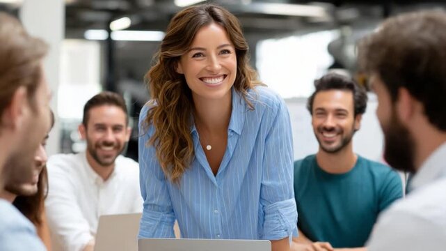 Confident Leadership: A smiling leader, radiates warmth and confidence as she engages her team, fostering an environment of collaboration and mutual respect.