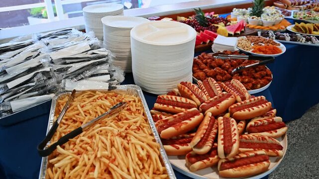 Buffet table with hot dogs, fries, and salads on cruise ship. Close-up of cruise ship buffet table with hot dogs, french fries, and salads ready for guests.