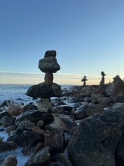 Stone balancing tower photographed in daylight with clear blue sky, symbolizing stability, strength, focus and natural harmony. Perfect for business concepts, coaching, leadership, wellness