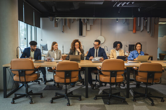 Diverse business team collaborating during meeting in modern office