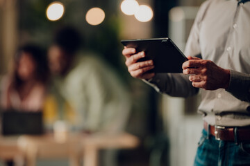 Businessman holding tablet during corporate presentation