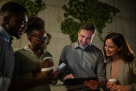 Diverse business team collaborating using digital tablet