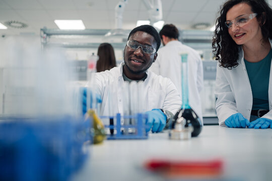 Diverse scientists collaborating in modern chemistry laboratory