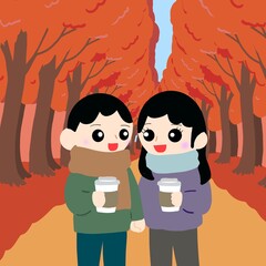 カップルがそれぞれホットドリンクを持ちながら散歩