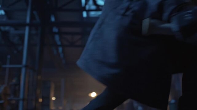 Ominous hooded figure wielding a scythe in factory