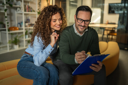 Business colleagues discussing work project using digital tablet in office