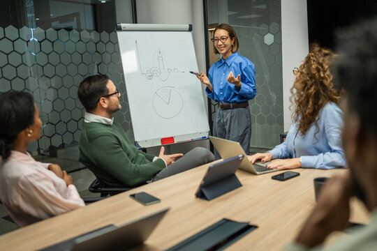 Business colleagues discussing data during corporate meeting in office - Powered by Adobe