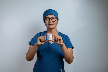 A doctor with a bottle of medicine in his hand.