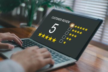 Customer review rating interface on a laptop screen showing five-star feedback, representing customer satisfaction, service quality evaluation, and digital user experience analytics.