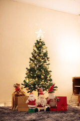 Cozy Christmas living room with a simple decorated tree, warm fairy lights, gold ornaments and festive gifts. Minimalist holiday decor perfect for modern, hygge, warm and authentic seasonal content.