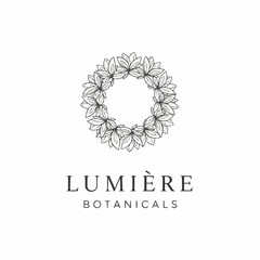 Elegant botanical logo with a circular wreath of leaves for a beauty brand.