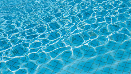 Swimming pool water surface with light reflection