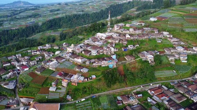 Cinematic aerial drone footage of Nepal Van Java village landscape in Central Java, Indonesia. Lush green hills and rural countryside captured in 4K with a serene and natural atmosphere.