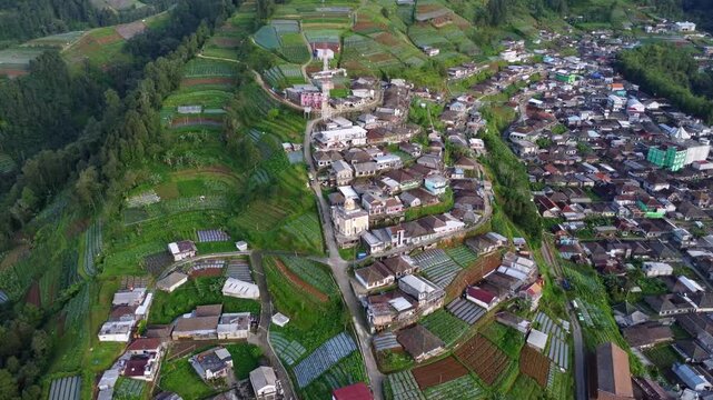 Cinematic aerial drone footage of Nepal Van Java village landscape in Central Java, Indonesia. Lush green hills and rural countryside captured in 4K with a serene and natural atmosphere.