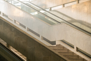 steps of the stairs and escalator leading up for the background