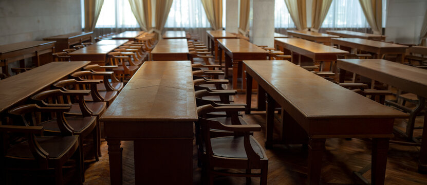 vintage brown tables and chairs in a classroom for background - Powered by Adobe