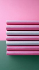 Close-up of a stack of pink and gray paper rolls against a colorful background. The image is well-lit and features a minimalist aesthetic.