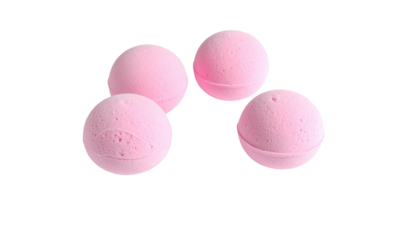 Pink bath bombs arranged on a black backdrop, exhibiting a soft, textured surface