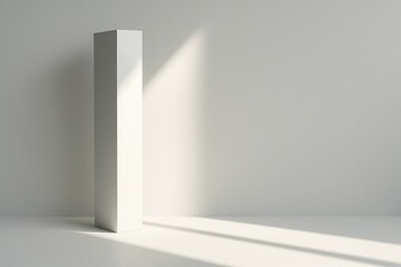 Fototapeta premium Tall minimal white column casting long diagonal sunlight shadows in a clean modern interior