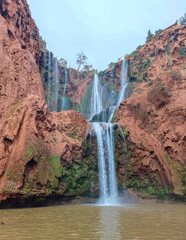 Multi-tiered Waterfalls Cascading Down Dramatic Red Sandstone Cliffs in Ouzoud, Morocco