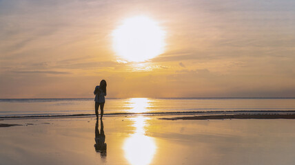 Silhouette woman Traveler Beach Sunrise with Sea Reflections