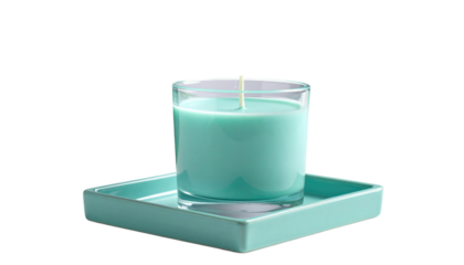 A lit aqua candle sits in a clear glass on a matching square ceramic base, against a solid black backdrop