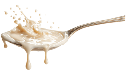 Condensed milk flowing down from spoon isolated on transparent white background.