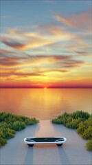 An electric skateboard is resting on a road leading towards a body of water at sunset. The sky is filled with vibrant colors.
