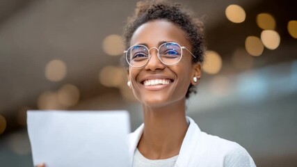 Vision of Success: A radiant woman gazes ahead, with glasses holding a document, a picture of drive and determination. capturing the essence of confidence and focus. 