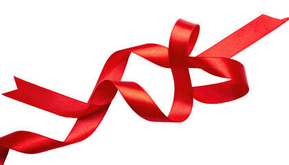 Red ribbon is twirled and tied loosely against a black background with a shiny, satin-like texture
