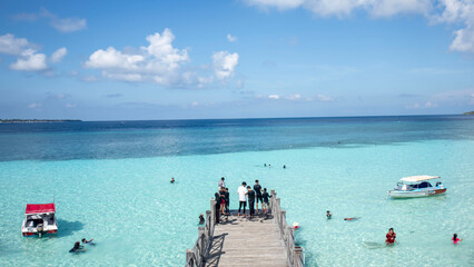 Tanjung bira beach with many people and pier
