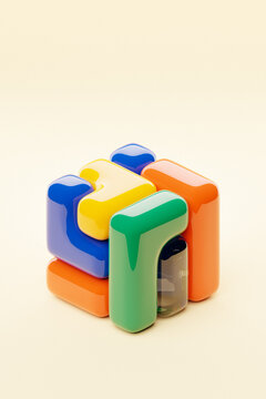 A stylized 3D cube featuring a palette of multiple colors, set against a lush red background, illustrating a digital abstract form