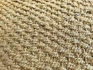 Detail of traditional Indonesian doormat made from natural coconut fiber, showcasing rustic texture and durable eco-friendly material for home entrance use.