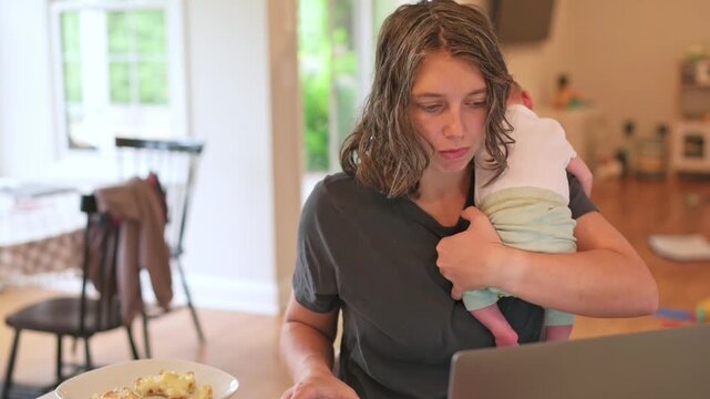 mother checking phone at kitchen table while holding baby, glancing between screen and child, soft natural light, casual clothing, everyday parenting moment with digital distraction