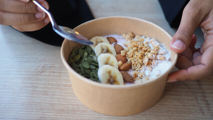 Healthy breakfast bowl with fruits and nuts served in a cafe