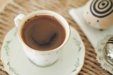 Enjoying turkish coffee in a cozy setting with artful accents