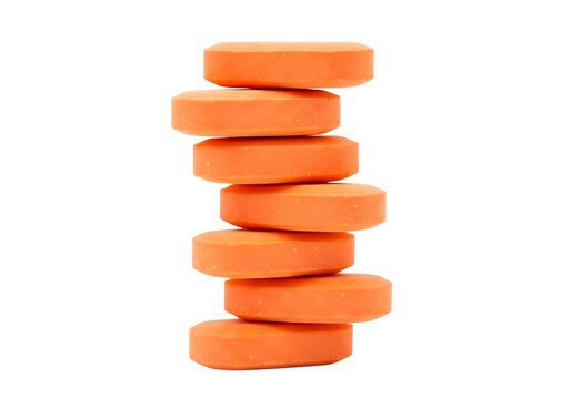Stack of orange oval pills isolated on transparent background